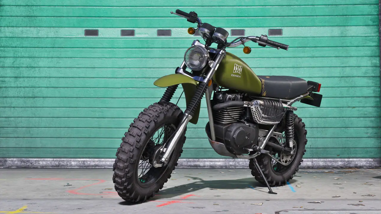 The Army-green Dinka Enduro motorcycle parked against a teal garage door