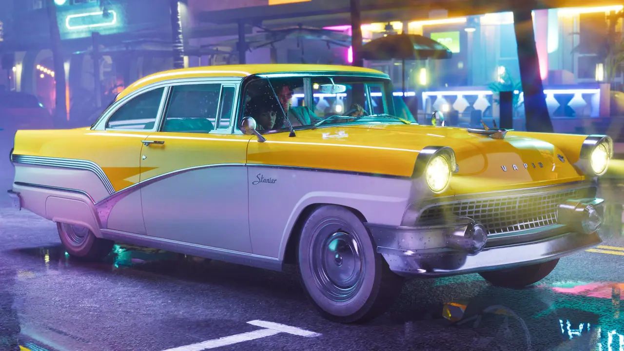 The yellow and white '55 Vapid Stanier under neon lights at night